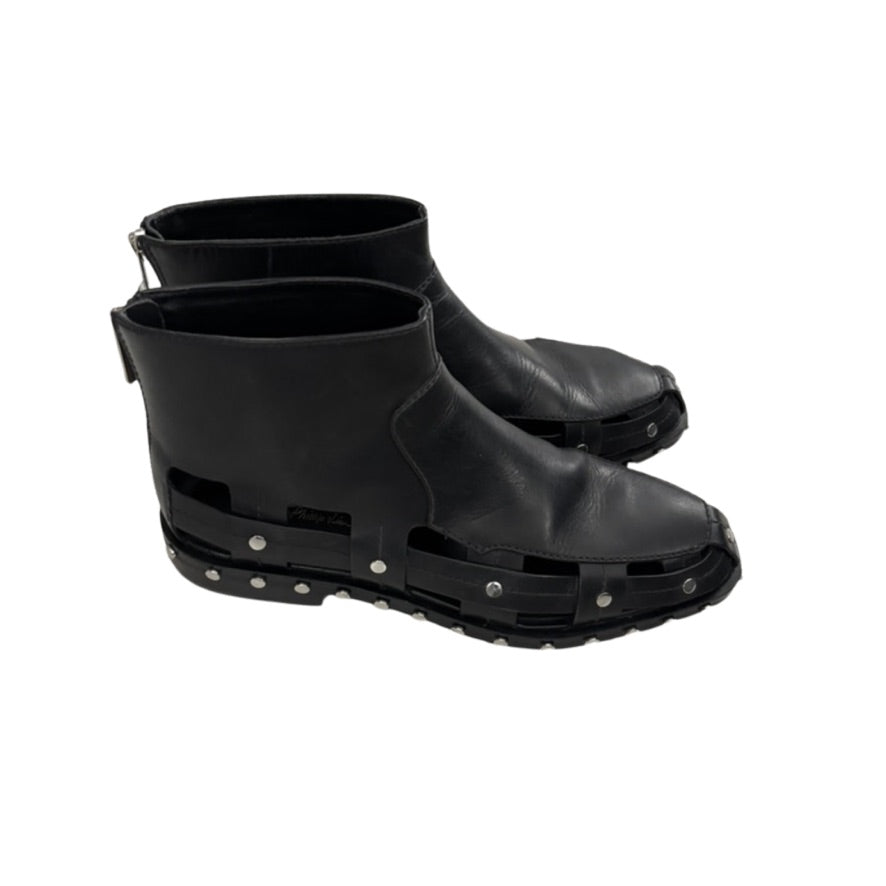 Pair of black leather ankle boots with unique design on a white background