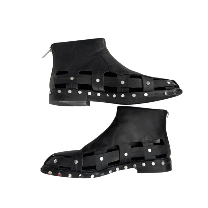 Black high-top shoes with studded design on a white background