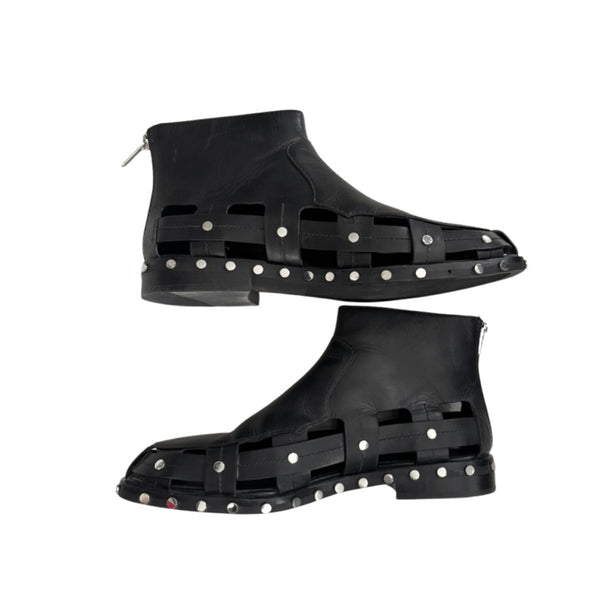 Black high-top shoes with studded design on a white background