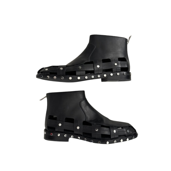 Black rubber boots with stud detailing on a white background