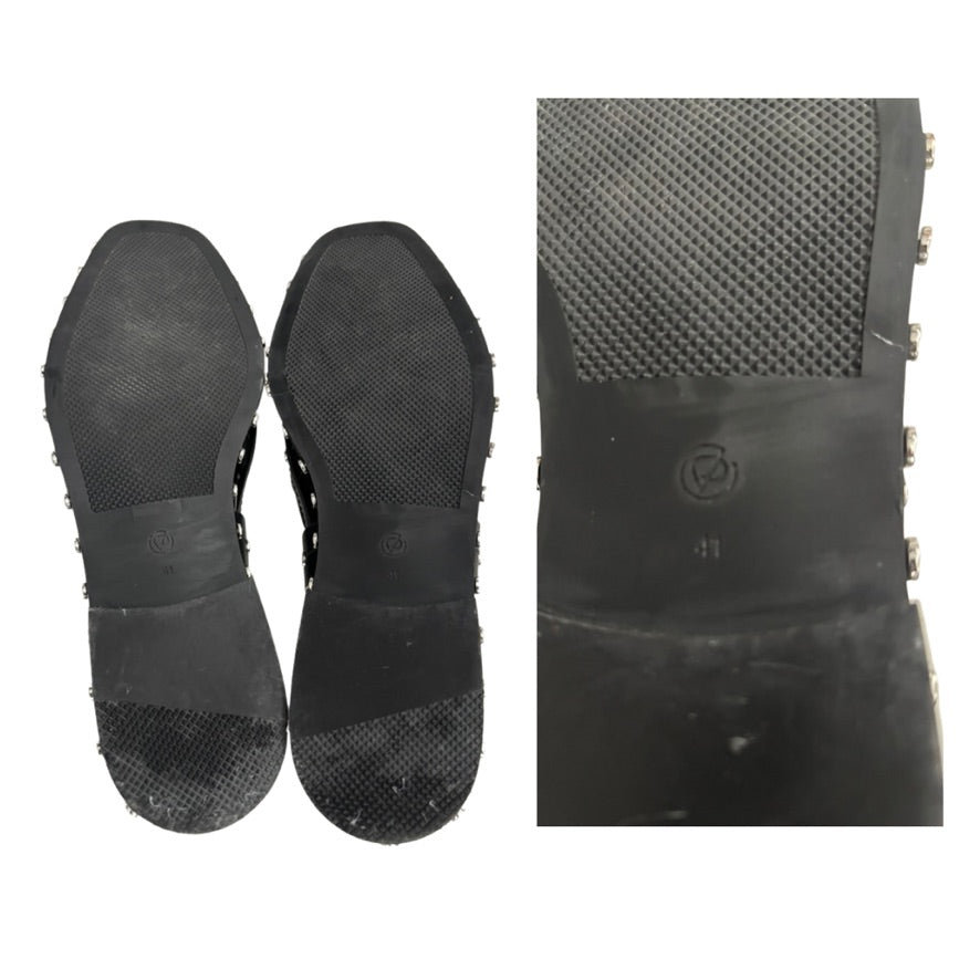 Black sole of a shoe with textured surface and brand logo on a white background