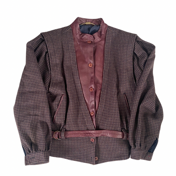 A vintage 80s checkered jacket with contrasting leather bib and belt, navy blue sleeves, and a high collar.