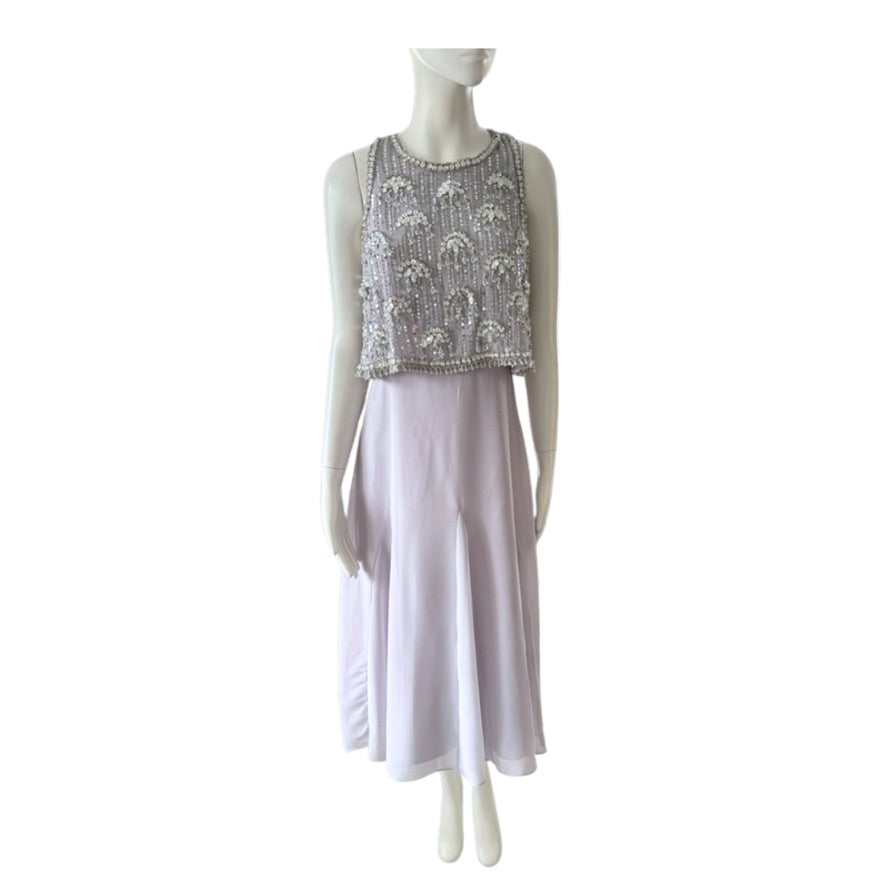 Mannequin wearing a light purple dress with a patterned top on a white background
