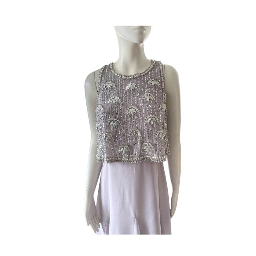 Mannequin wearing a silver beaded top on a white background