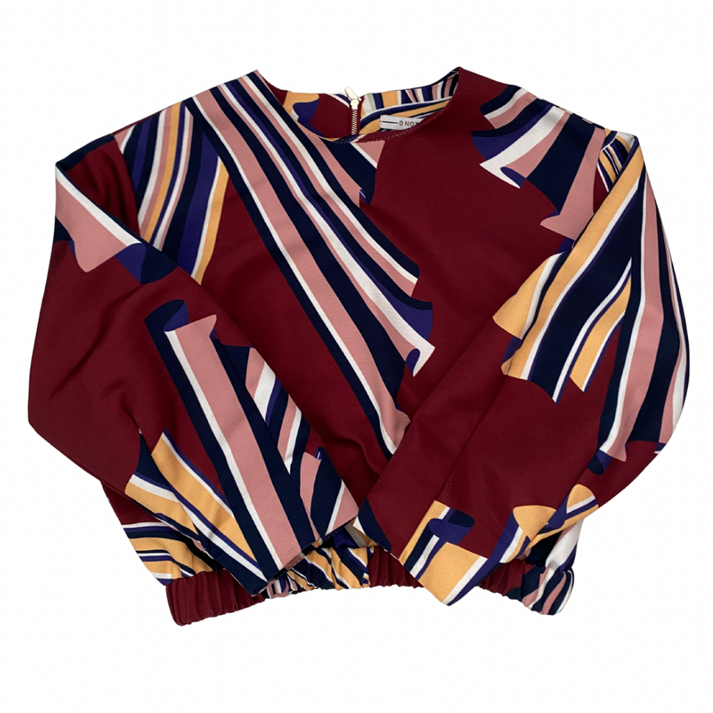 Colorful patterned top on a white background