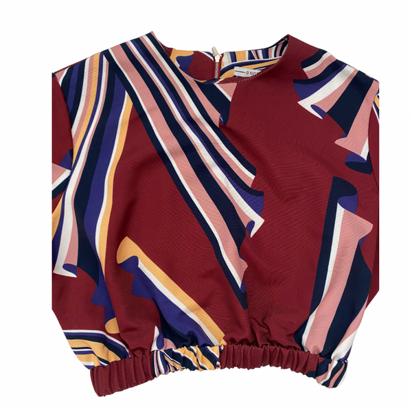 Colorful patterned top on a white background