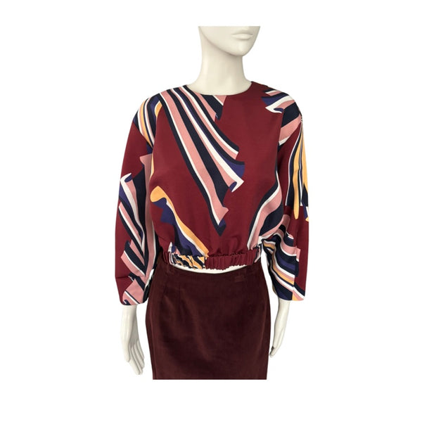 Mannequin wearing a patterned top and skirt set on a white background