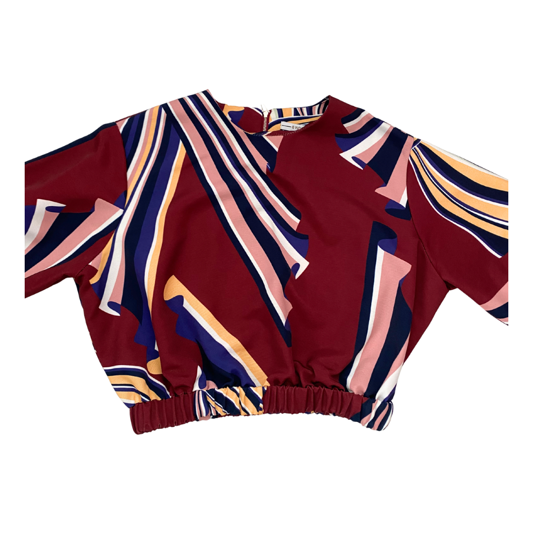 Colorful patterned top on a white background