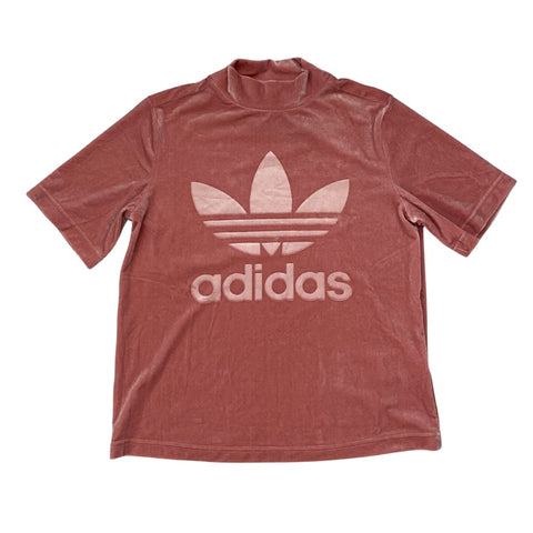 Pink Adidas t-shirt with white logo on a white background