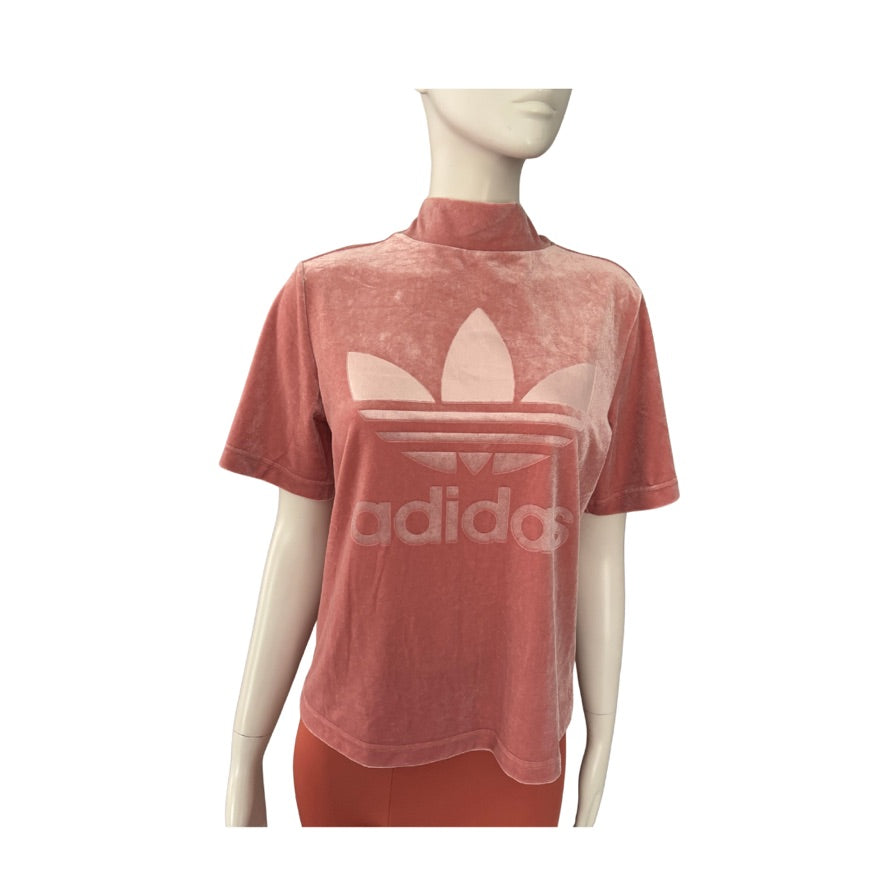 Pink Adidas t-shirt on a mannequin against a white background