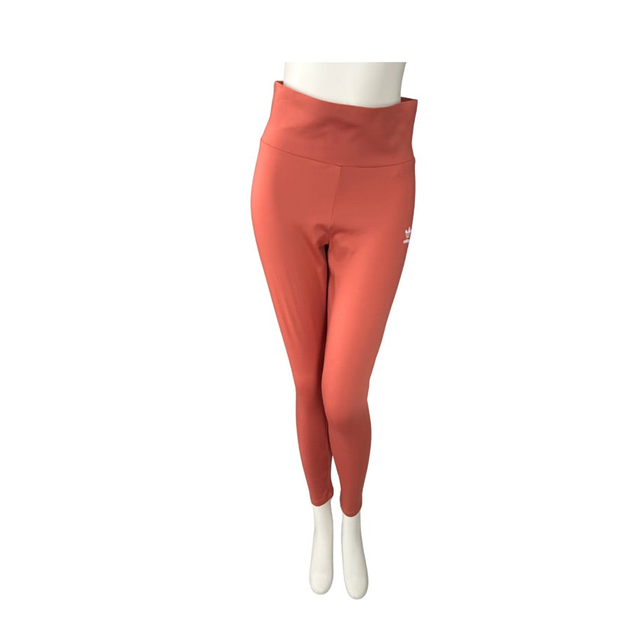 Orange leggings on a mannequin against a white background