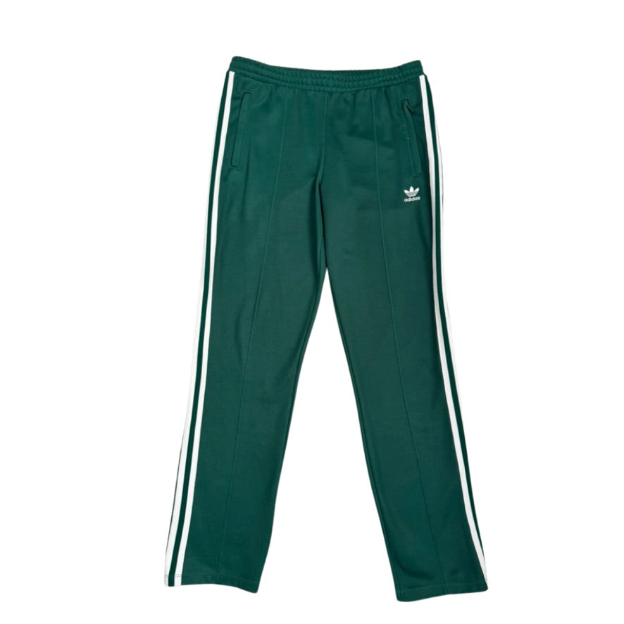 Green track pants with white stripes on a white background