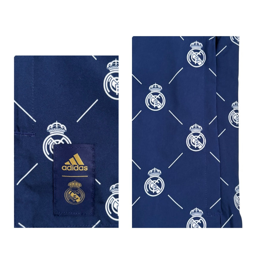 Navy blue pants with white Real Madrid logo pattern on a white background
