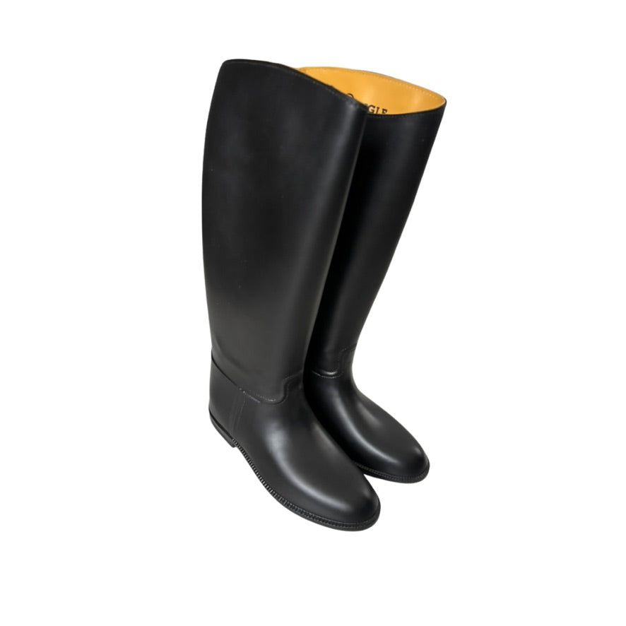 Pair of black rubber boots with yellow lining on a white background