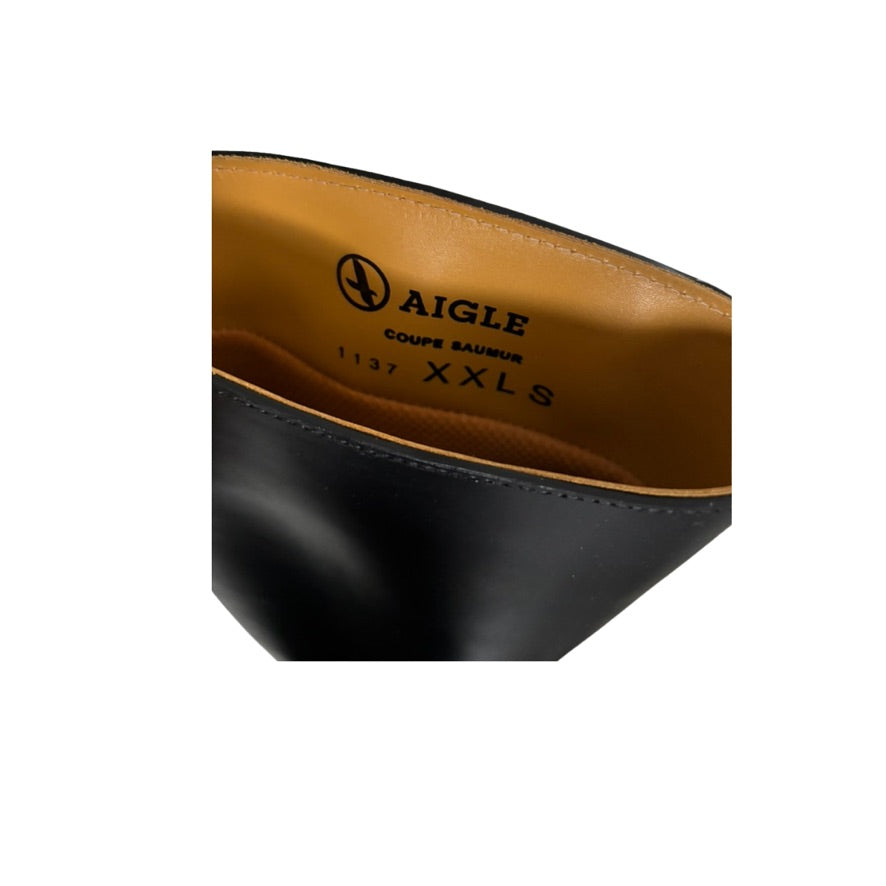 Close-up of a shoe with 'Aigle' branding on a white background