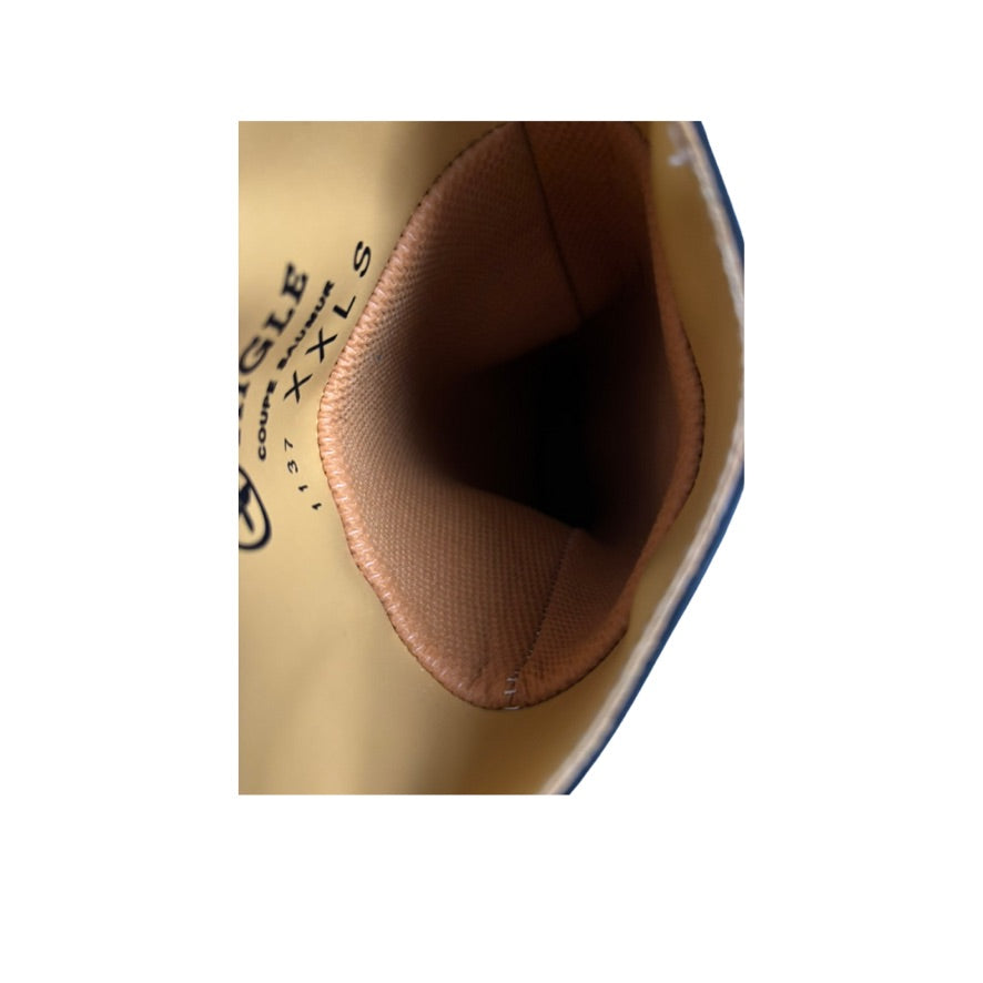 Close-up of a leather product with visible stitching on a white background