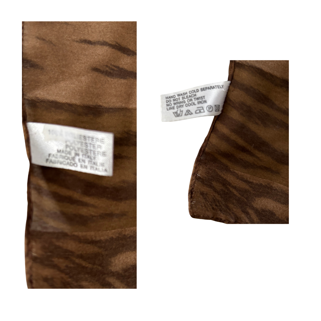 Close-up of brown fabric with a label on a white background