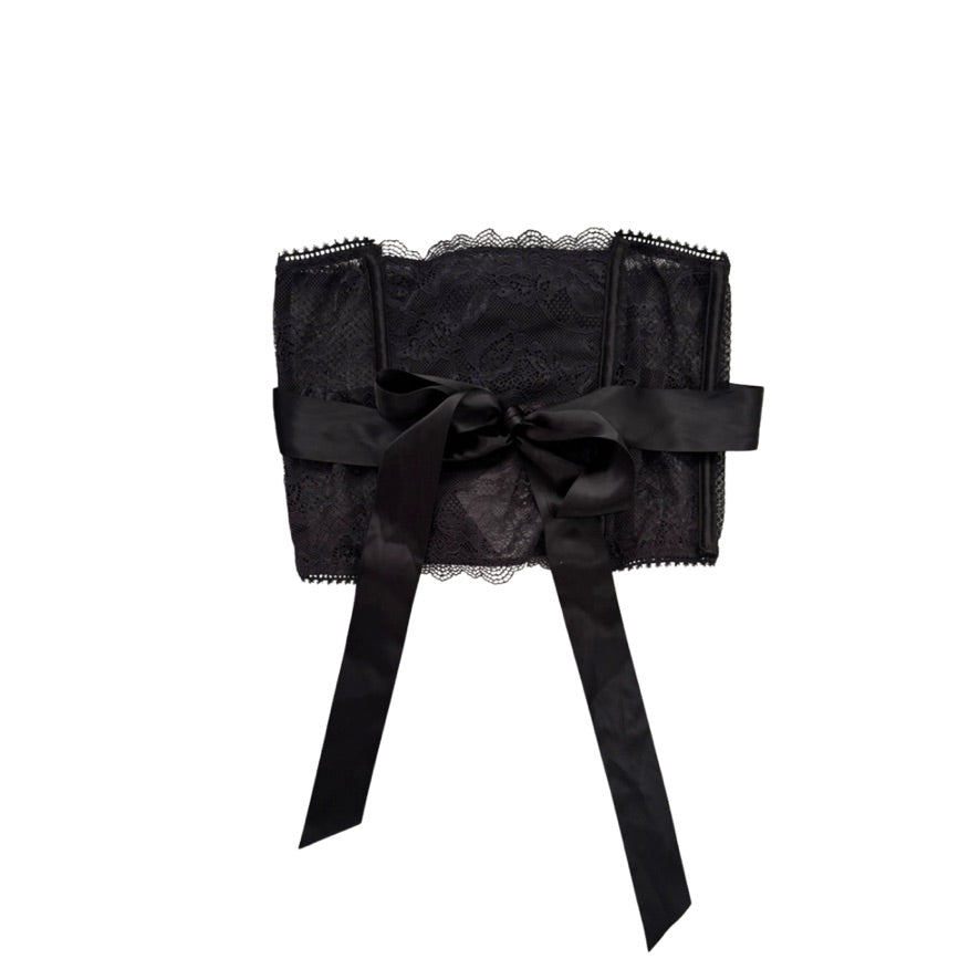 Black lace top with a large bow on a white background