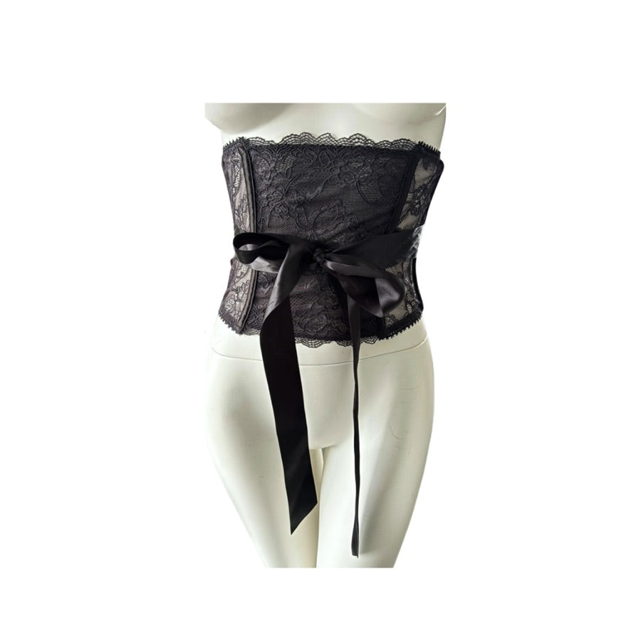 Black lace waist belt with a bow on a mannequin against a white background