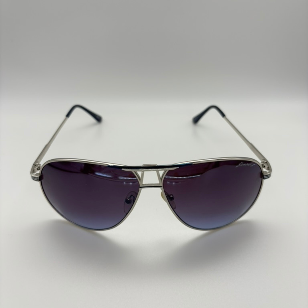 Aviator sunglasses with dark lenses on a light gray background