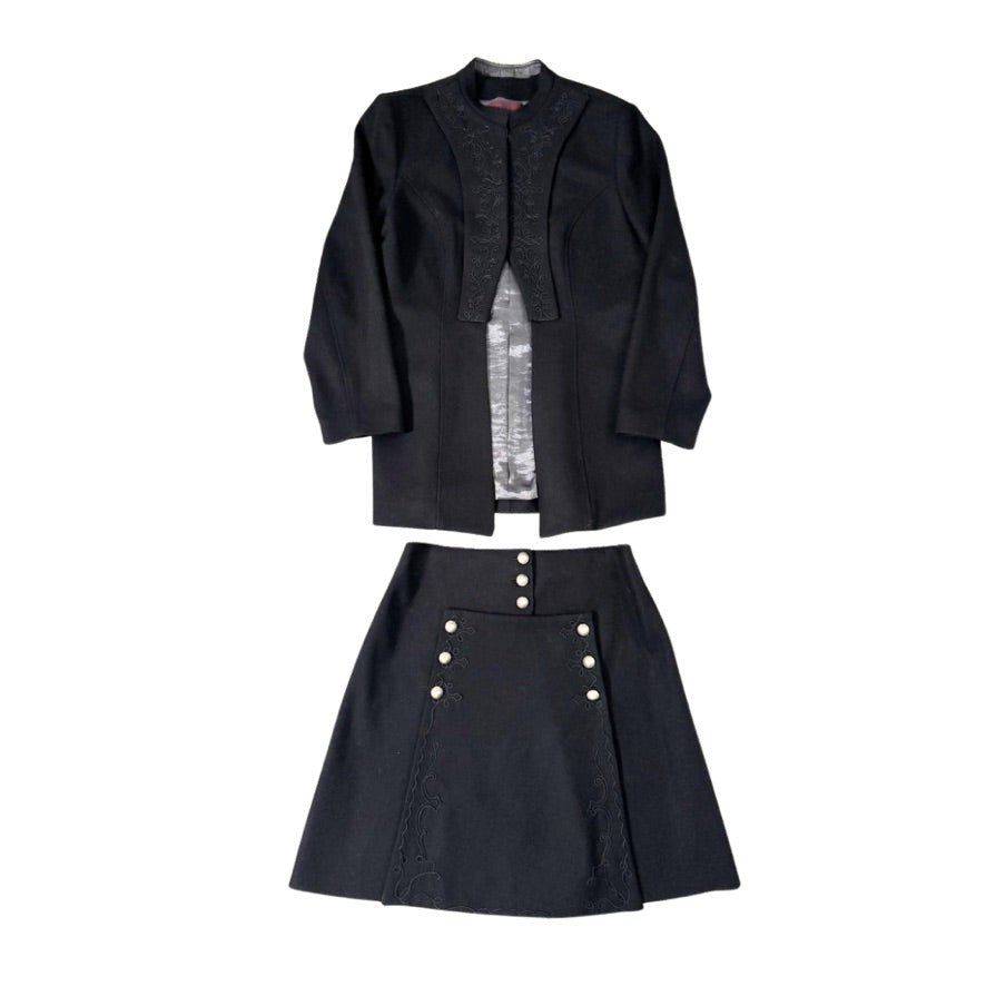 Black outfit with jacket and skirt on a white background