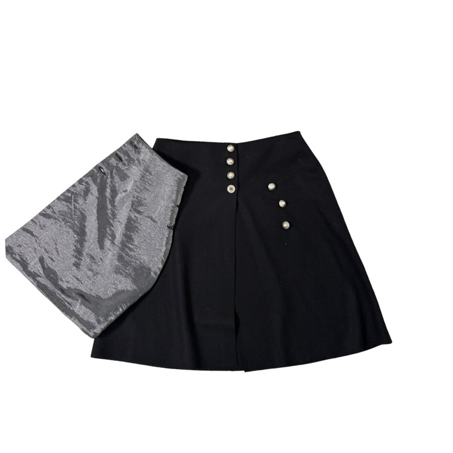 Black skirt with gray lining and white buttons on a white background
