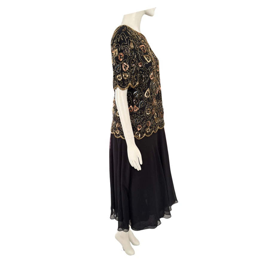 Mannequin wearing a black dress with a patterned top on a white background
