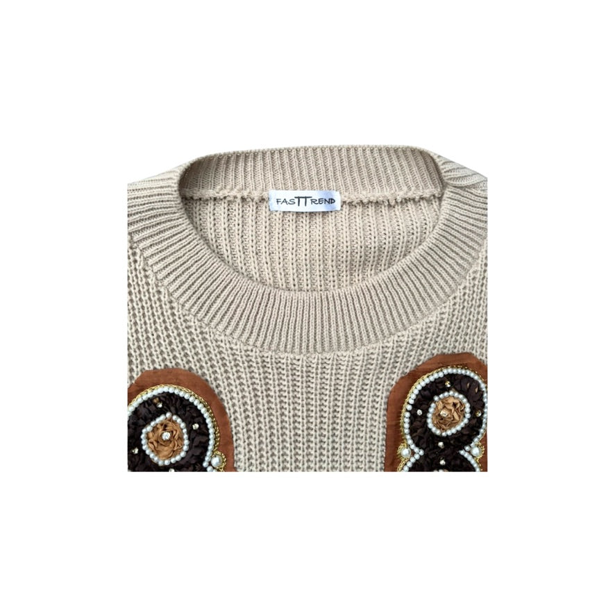 Beige sweater with brown and black embellishments on a white background