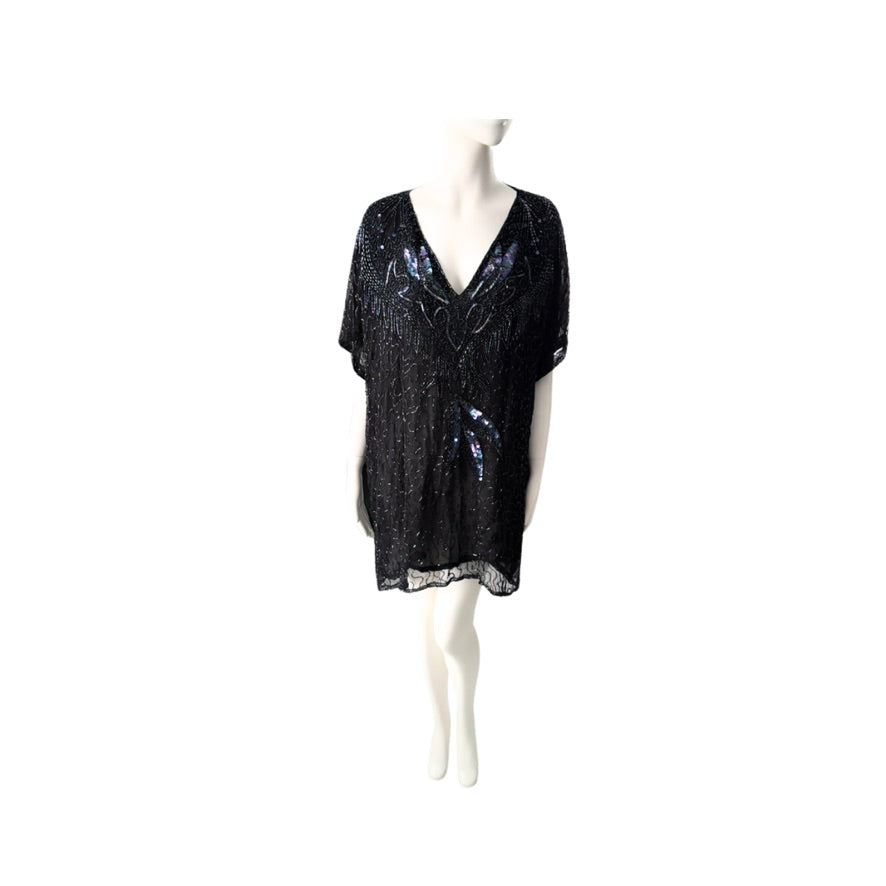Black sequin top on a mannequin against a white background