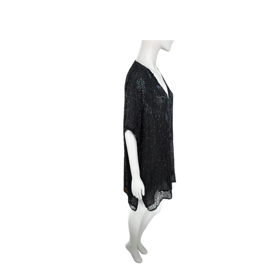 Black lace dress on a mannequin against a white background