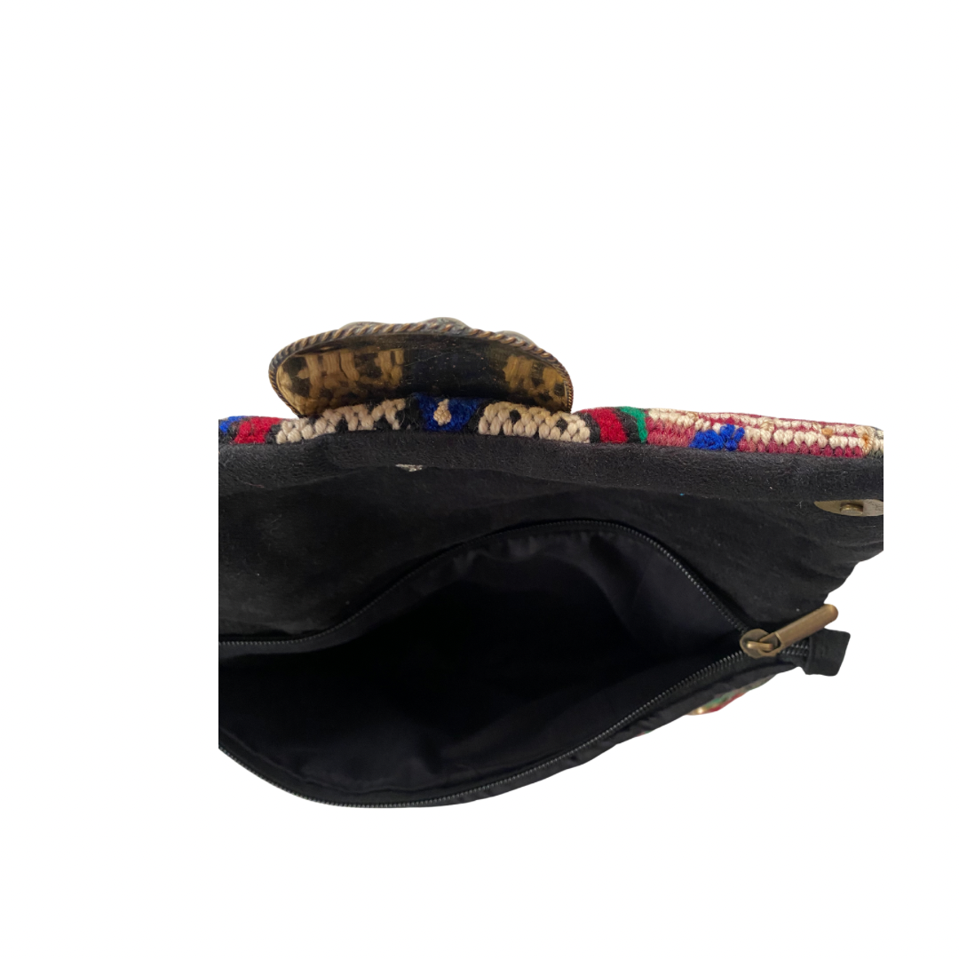 Black inside bag with colorful woven top on a white background