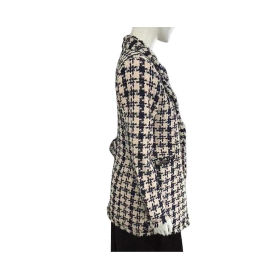 Houndstooth patterned coat on a mannequin against a white background