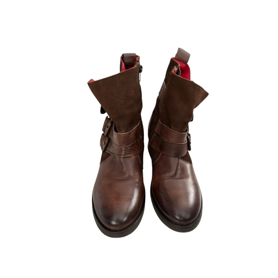 Pair of brown leather boots with red lining on a white background