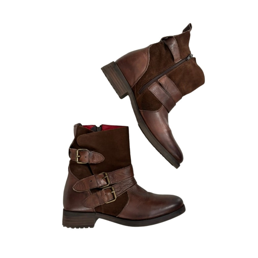 Brown leather boots with buckles on a white background