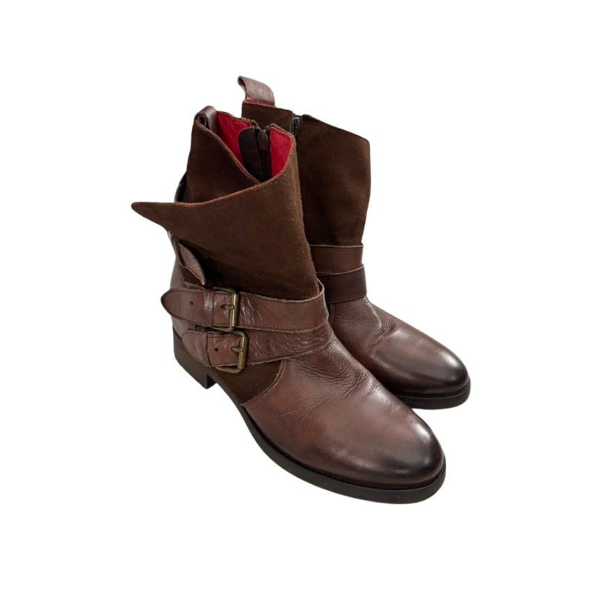 Brown leather boots with buckles on a white background