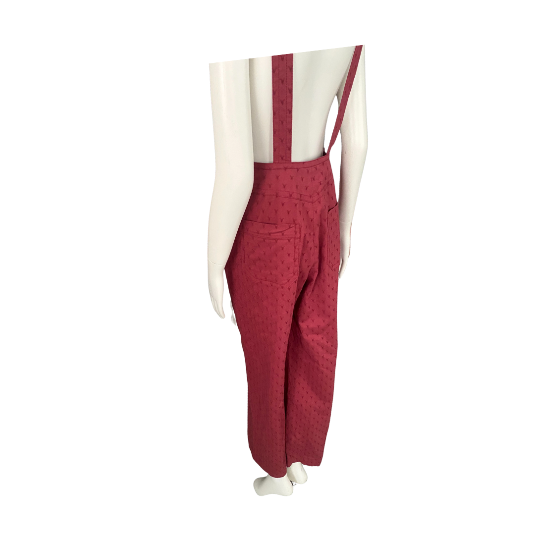 Red patterned overalls on a mannequin against a white background