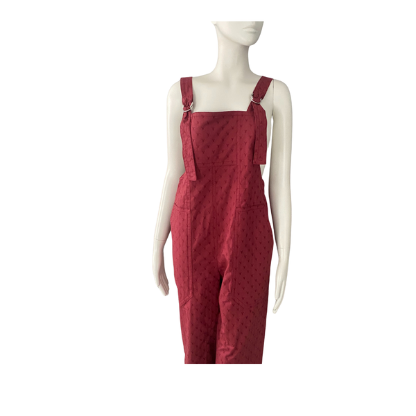 Red overalls on a mannequin against a white background