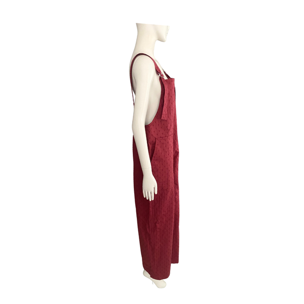 Red overalls on a mannequin against a white background