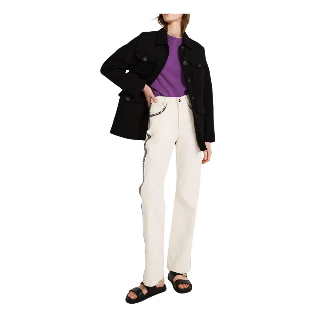 Person wearing a black coat, purple shirt, white pants, and black sandals on a white background