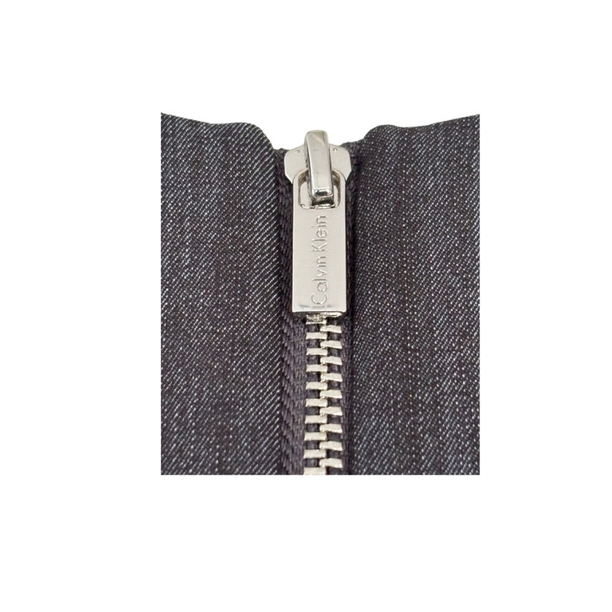 Close-up of a zipper on a gray fabric background