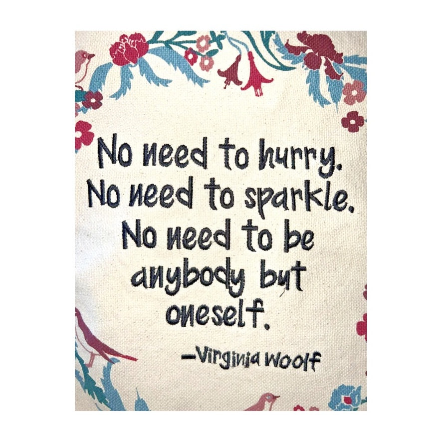 Motivational quote by Virginia Woolf with decorative elements on a floral border.