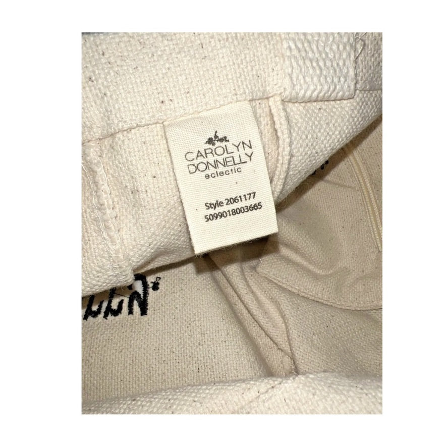 Close-up of a beige fabric with a brand label on a white background