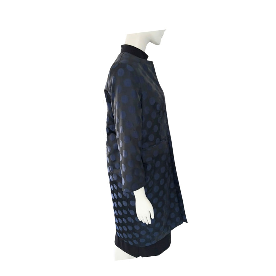 Mannequin wearing a black and blue patterned coat on a white background