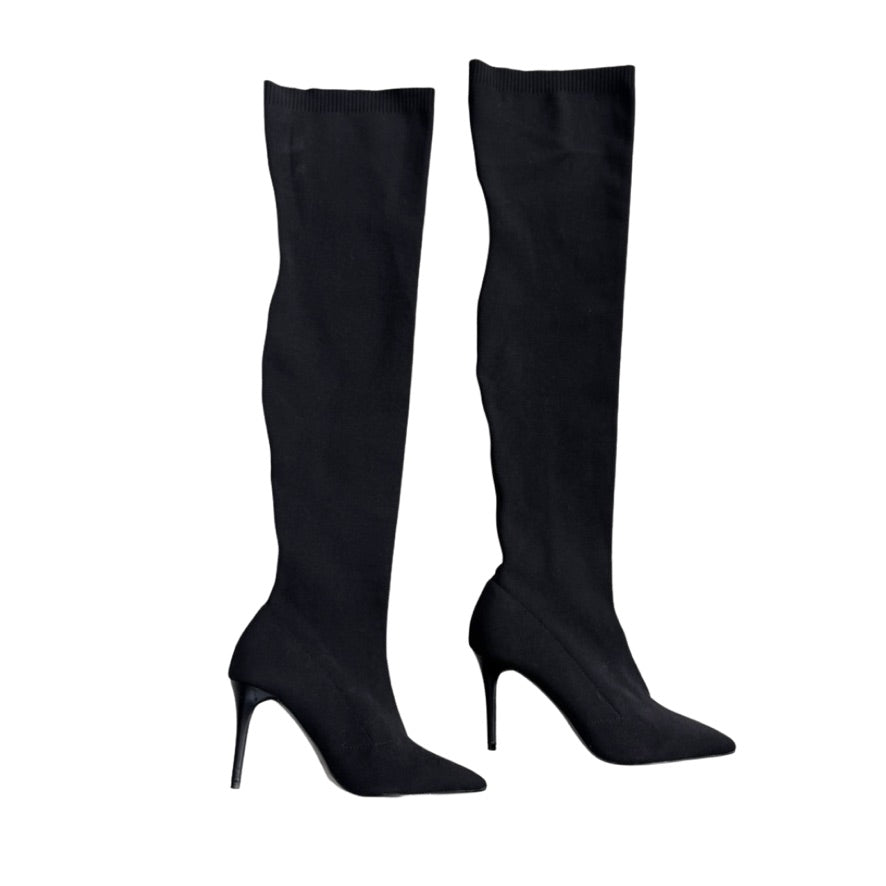 Black knee-high boots on a white background
