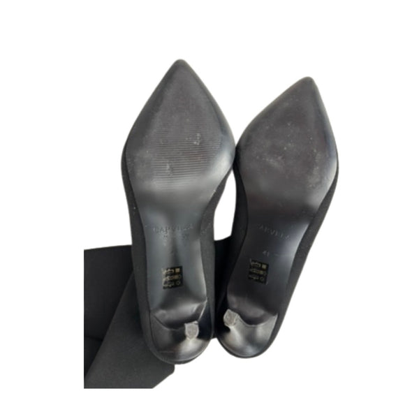 Pair of black high-heeled shoes on a white background