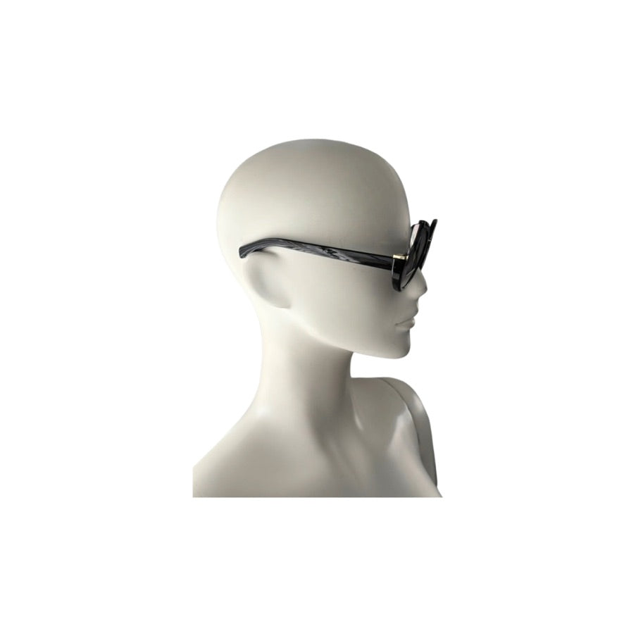 Sunglasses on a mannequin head against a white background