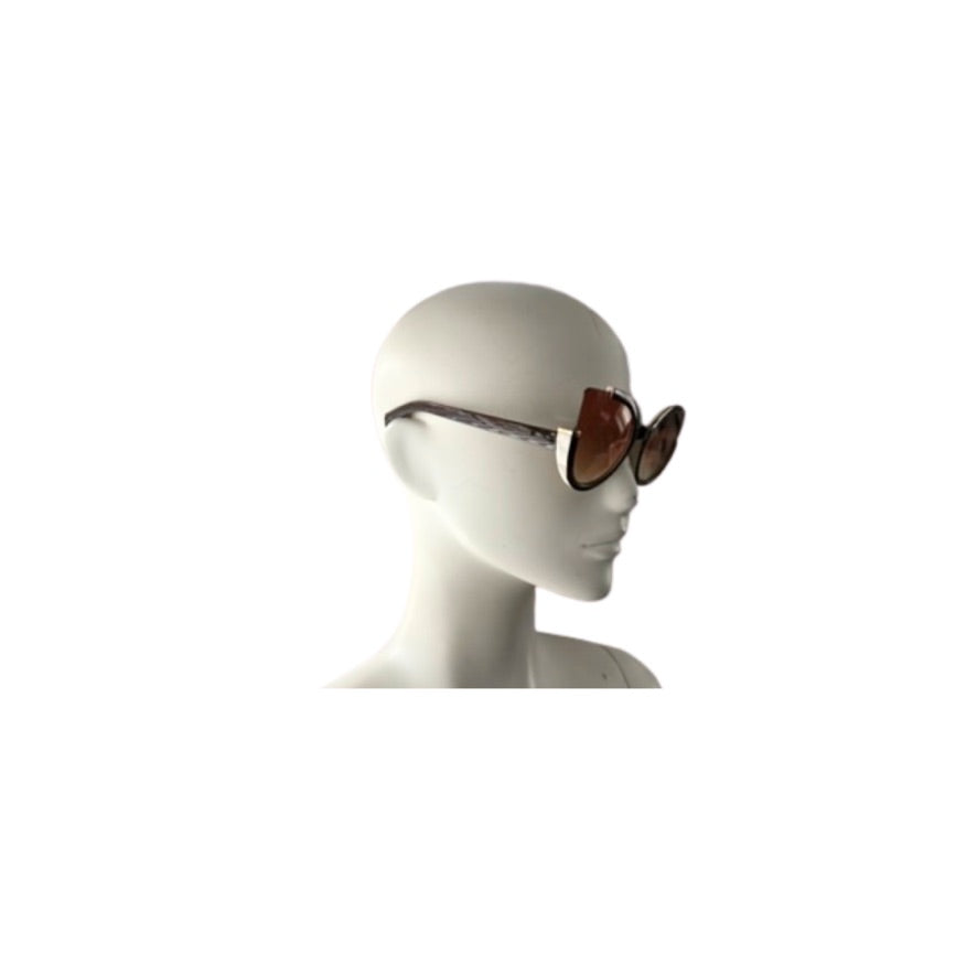 Sunglasses on a mannequin head against a white background