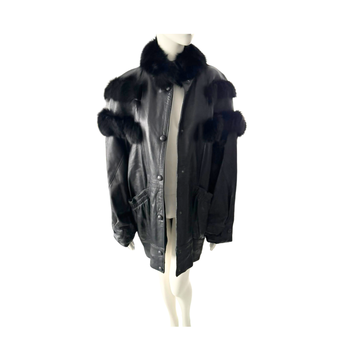 Black leather jacket with fur trim on a mannequin against a white background