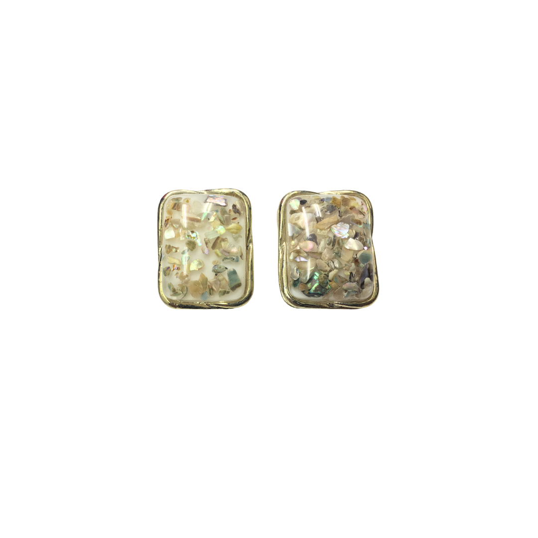 Pair of gold rectangular earrings with embedded stones on a white background