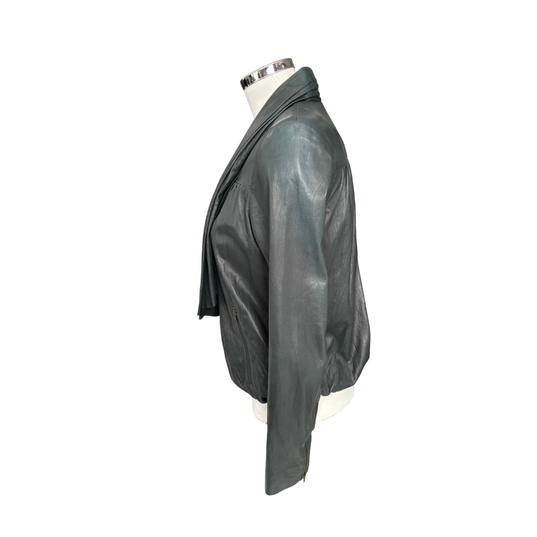 Green leather jacket on a mannequin against a white background